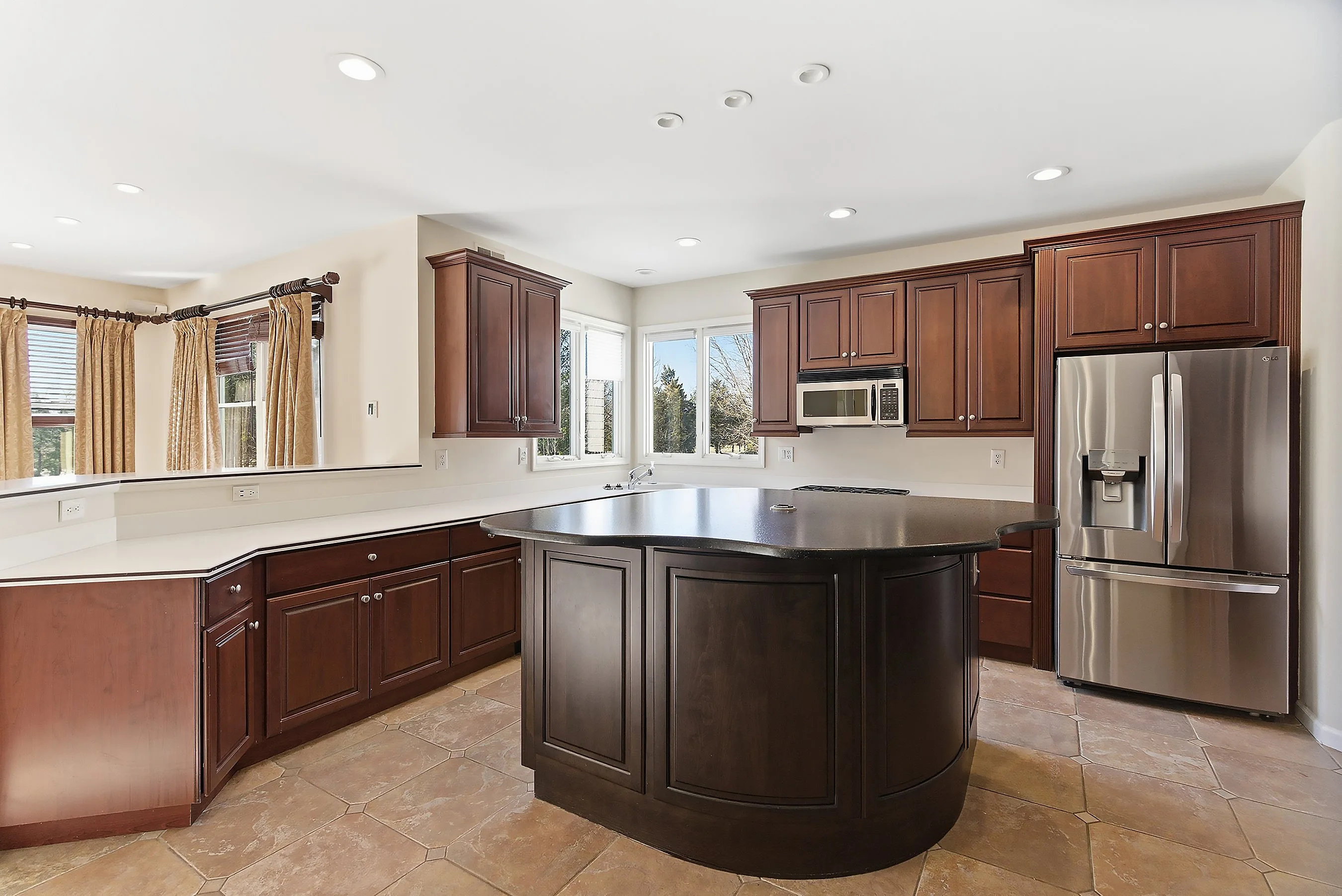 Kitchen before — dark cherry cabinets